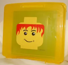 2009 YELLOW LEGO CASE MINI FIG HEAD WITH RED HAIR HAS THE GREEN BUILDING BASE