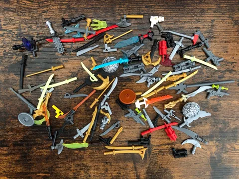 Lego Lot of Assorted Weapons. (Guns, Swords, Spears, bombs, Axes, Shields Etc.) 