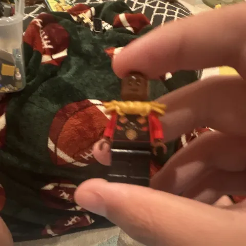 A Lego Mini figure Of Okoye From Marvel Super Hero’s Set 76247