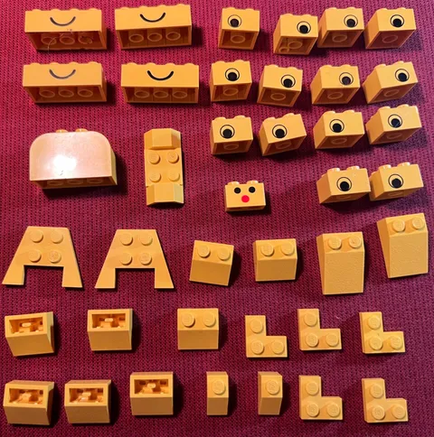 Lego lot of 40 assorted YELLOW items: slopes, corner plates, faces, etc.