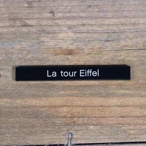 LEGO Black Tile 1 x 8 with 'La tour Eiffel' Pattern 4162pb107 from Set 21019