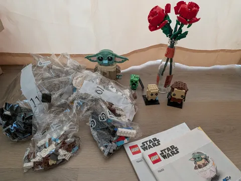 baby Yoda with carrier lego set, frodo and gollum Lego set, and Lego roses