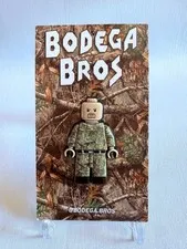 Bodega Bros Pin Stone Cold Steve Austin Camo Minifig style.
