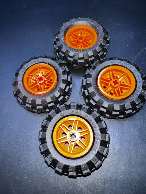 LEGO Lot of 4 Black 56x26 Tires with Red Technic Hubs