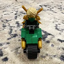 LEGO NINJAGO Minifigure w/ Blonde Hair & Gold Swords on Green Tracked Vehicle