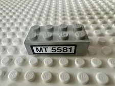 LEGO Brick 2 x 4 with Black 'MT 5581' on White Background 3001pb040