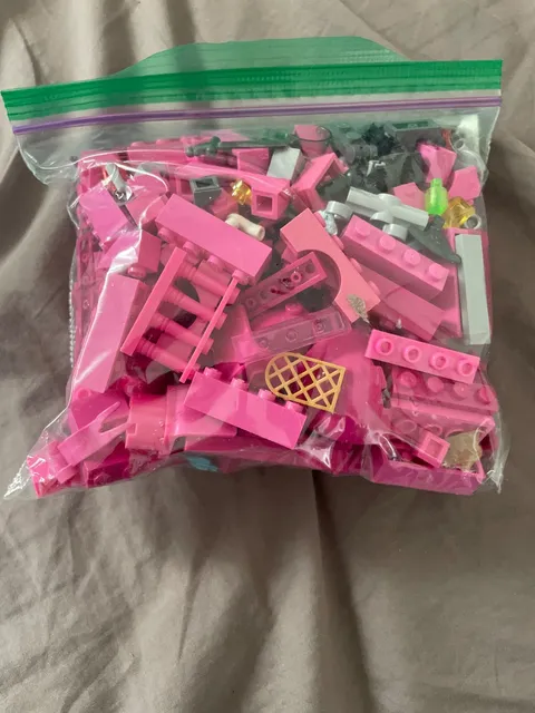 1/2 lb bag of random pink and black lego pieces - used pieces - random pieces