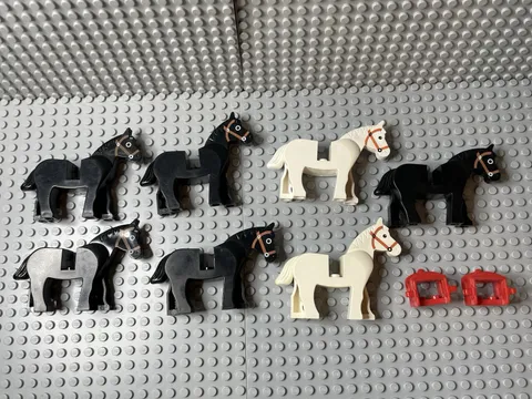 LEGO. Lot of 7 Horses (5 black, 2 white) and 2 Red Saddles. Used.