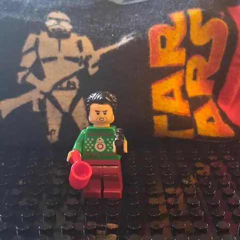 LEGO Minifigure Dark Hair Green Sweater Torso Red Legs with Red Mug