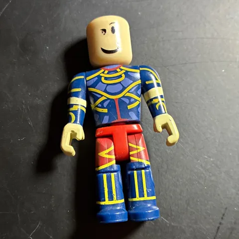 LEGO Minifigure Blue & Yellow Printed Torso w/ Red Legs, Smiley Face, No Hair