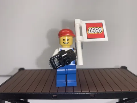 LEGO flag man with Overalls Striped Blue red cap and camera.
