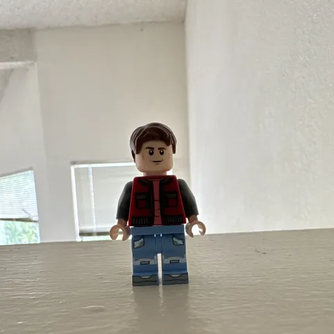 LEGO Minifigure Red Vest, Gray Sleeves, Light Blue Legs, Brown Hair