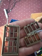 Lego Door Frames gold in color and 2 windows