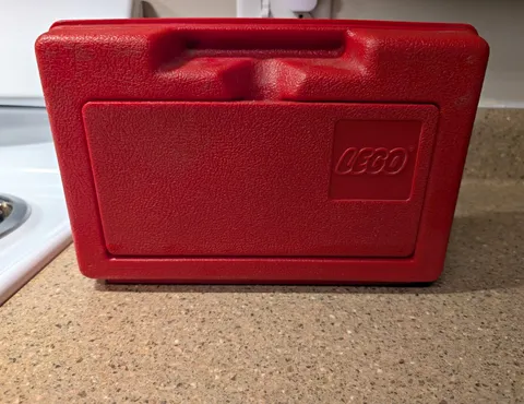 vintage 1980s red plastic Lego carrying and storage case by Interlego.